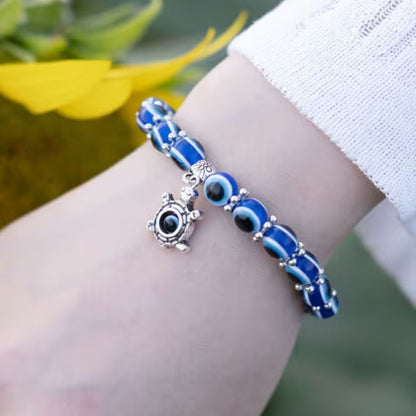 Blue Evil Eye Beaded Stretch Bracelet With A Turtle Charm